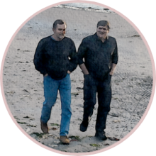 Mark Pearson and Mike McCoy walking with each other on a beach