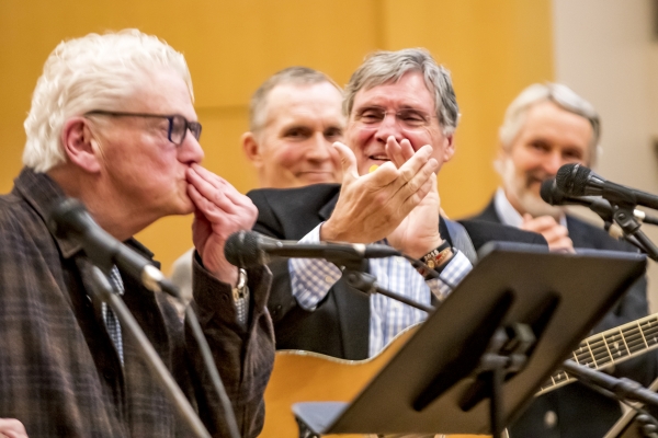 Image of Mike Kirkland blowing a kiss to audience while Mark and Mike are applauding in the background.