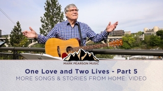 One Love and Two Lives Part 5 episode image, Mark with his guitar on a balcony overlooking a lush cityscape in the sun